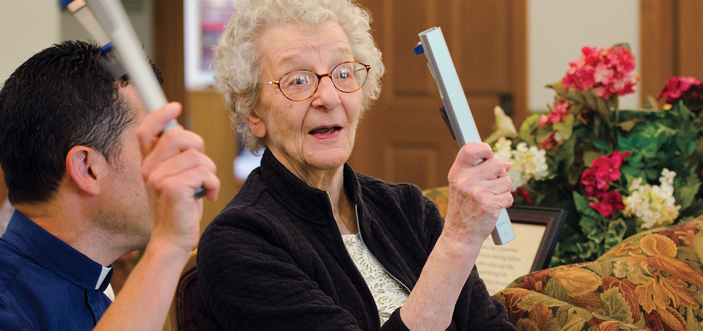 senior playing chimes with pastor