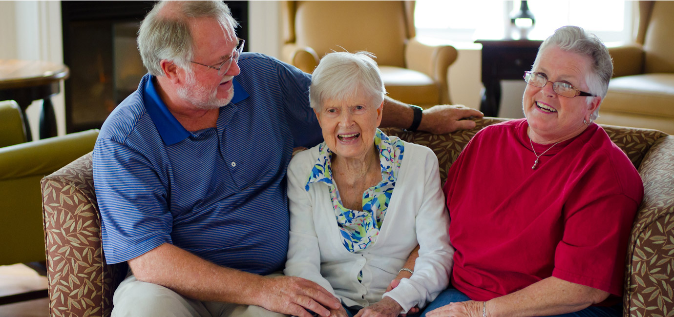 three people sitting on a couch