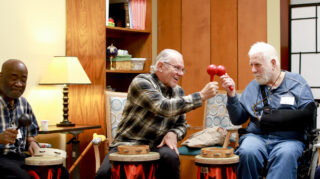 Seniors playing percussion instruments in a drum circle.