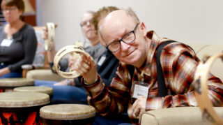 Member plays tambourine