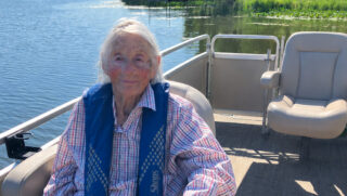 A member of Open Circle of Princeton enjoys a sunny pontoon boat ride on the water.